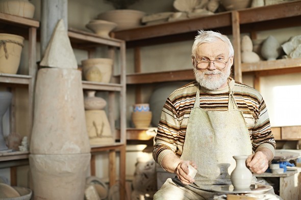 Experienced craftsman creating ceramic jug