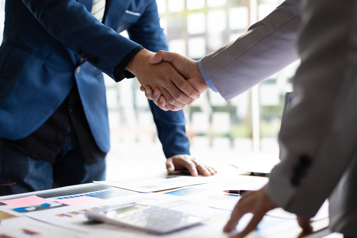 Business partners shaking hands after a meeting.