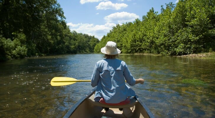 Woman canoeing down a river in Missouri