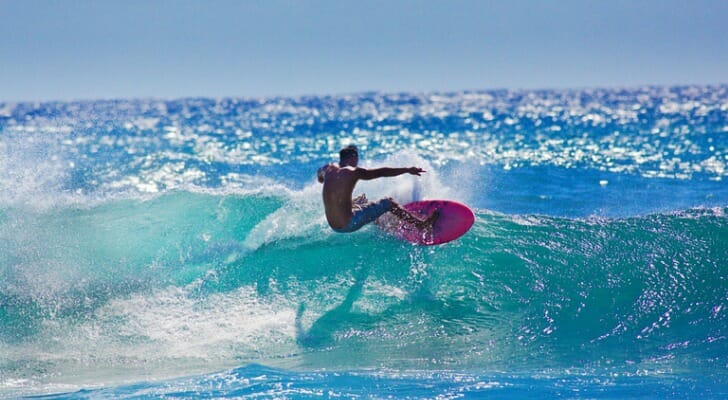 A local Hawaiian surfer surfing at Poipu Beach, Kauai, Hawaii