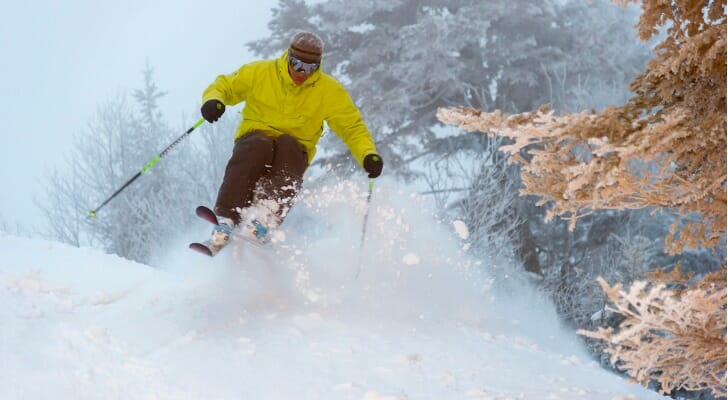 An expert skier going down the side of a snowy Vermont mountain