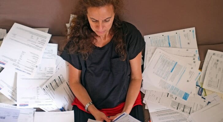Woman surrounded by financial documents