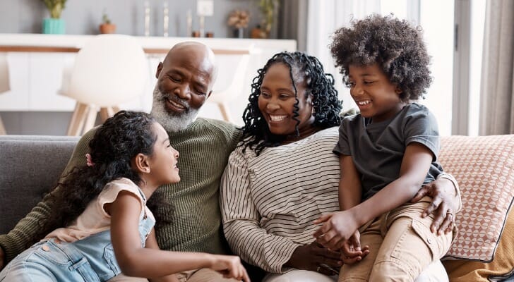 Image shows a multigenerational family sitting together in their living room. SmartAsset analyzed Census data to conduct its latest study on the states where multigenerational households are becoming more common.