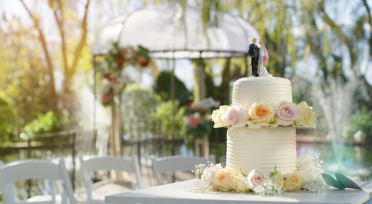 A wedding cake sits on a table at a wedding reception. SmartAsset examined 95 of the largest cities in the U.S. to find the best cities for an affordable wedding.