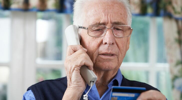 Elderly man giving his credit card number out