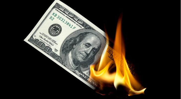 One-hundred dollar bill burning