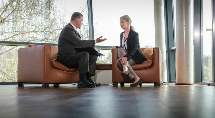 Image shows a client speaking to a wealth advisor about long-term goals for preserving their wealth.