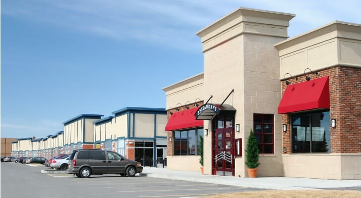 Image shows a strip mall. Strip malls remain a solid investment, either through direct purchase or investing in a real estate investment trust (REIT).