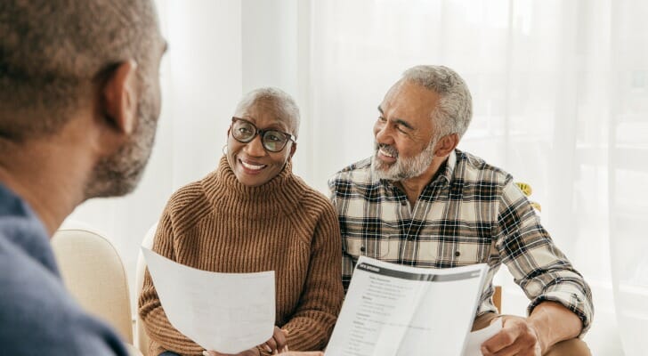 A financial advisor assists a couple with their estate plan. A recent survey of 10,000 found that only about half have an estate plan. 