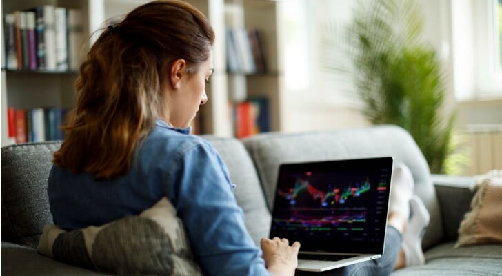 A woman reviews her investment portfolio on her laptop. Dimensional found that some small-cap stocks with high price tags and low profits may be reducing your portfolio's returns.
