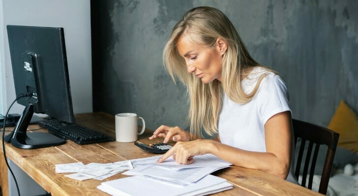 A woman looks over her finances. An annual survey conducted by TIAA Institute and the Global Financial Literacy Excellence Center (GFLEC) at the George Washington University School of Business found that adults could correctly answer only one-half of the questions, on average, a troubling figure that has remained stagnant over time.
