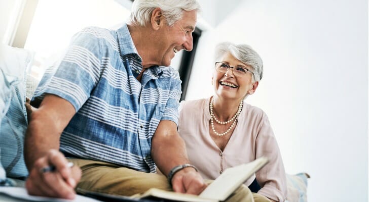 A retired couple talks about their financial plan. TIAA is launching an annuity option within its 401(k) plans. 