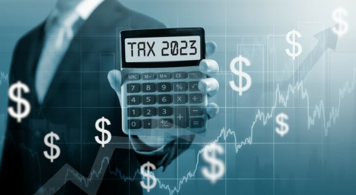 tax-2023-on-calculator-businessman-hold-and-show-calculator-with-word-tax-2023-concept-SmartAsset