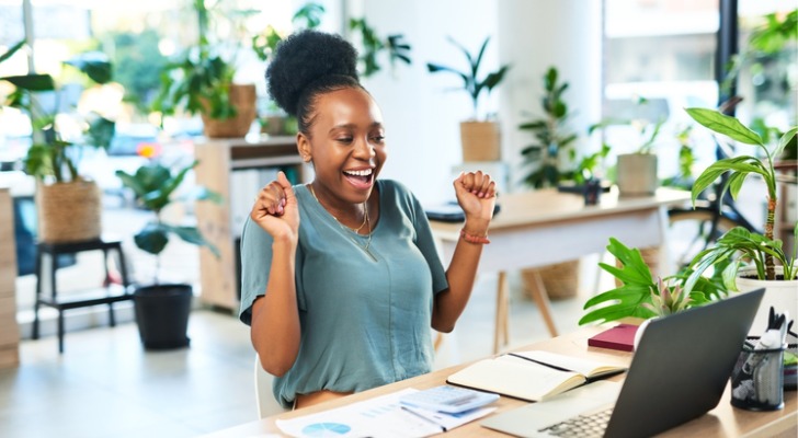 A woman excited to learn about how much she will make in dividends with her $100,000