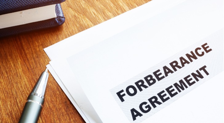 A pen rests next to a forbearance agreement.