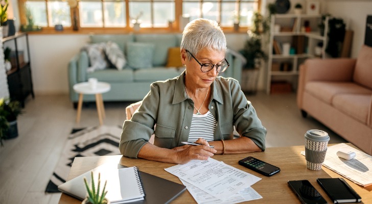 A woman looks over a financial statement for her retirement savings.