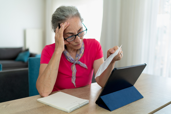 An older woman studies her tax-advantaged accounts