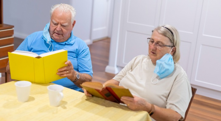 Senior couple reading up on longevity literacy