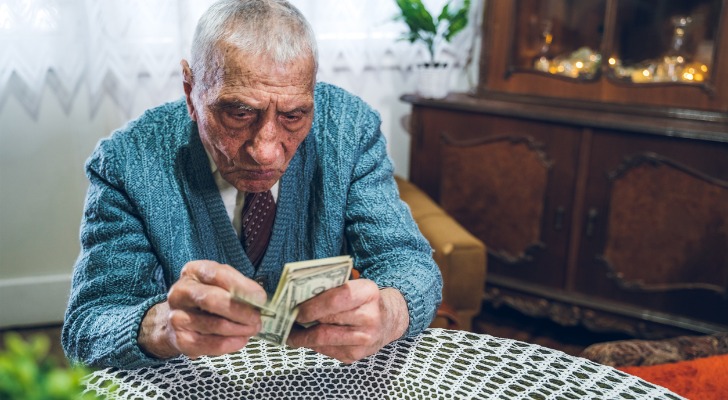 A man counting his money and trying not to run out during retirement
