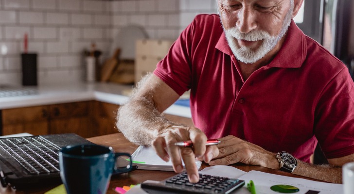 A man calculating interest on his 401(k) loan.