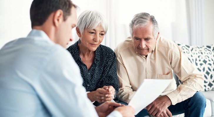 Older couple works on their retirement plans with a financial advisor
