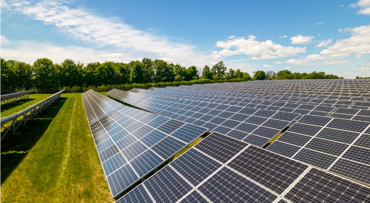 Rows of sustainable energy solar panels set up on the farmland.