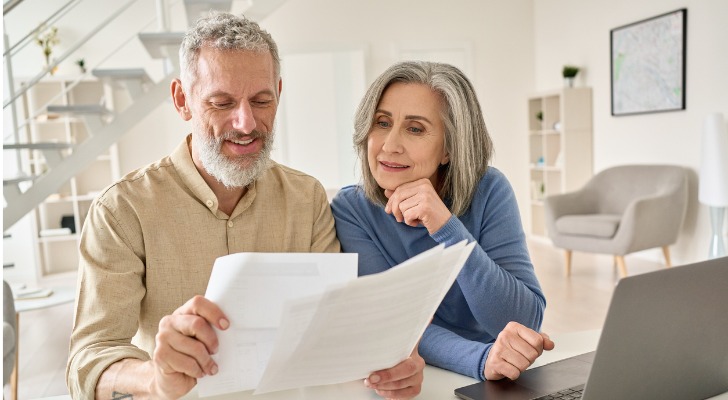 A middle-aged couple reviews their retirement plan as they consider purchasing an investment-only variable annuity (IOVA)