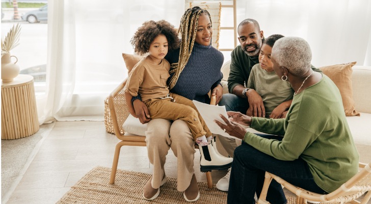 A woman goes over her estate plan with her daughter, son-in-law and grandchildren.