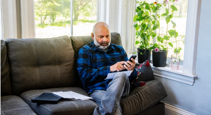 A man looks over his 401(k) and IRA to determine which account he should withdraw money from.