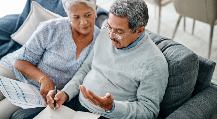 A couple in their mid-60s calculates how much they can contribute to their Roth IRAs. 