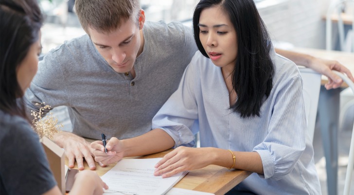 A couple reviewing the value of their personal property with an insurance agent.