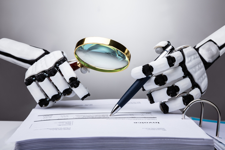 Photo Of Robot Examining Invoice With Magnifying Glass
