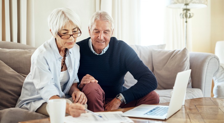 A couple reviewing the terms of a peer-to-peer loan investment.