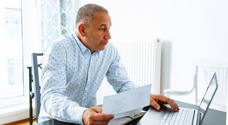 A man calculates how much his Social Security benefits will be if he claims them at age 62 vs. his full retirement age. 