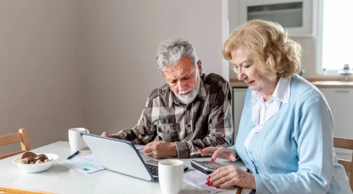 A couple trying to calculate their benefits for early retirement.