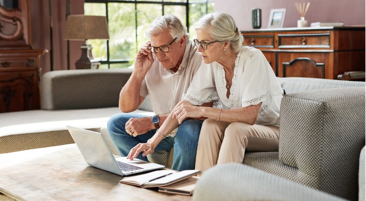 A husband and wife who are both 67 look over their assets as they set a retirement budget.