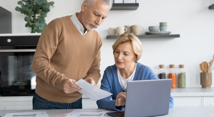 A senior couple reviewing tax breaks to reduce their tax liability.