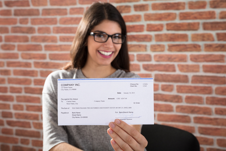A woman receives a check for a personal grant that she may have to pay taxes on.