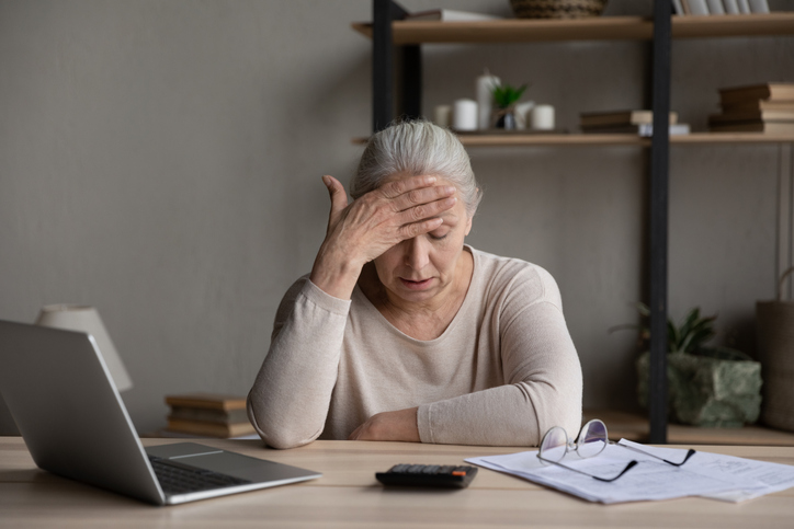 A senior woman worried about missing withdrawal rules for her retirement accounts.