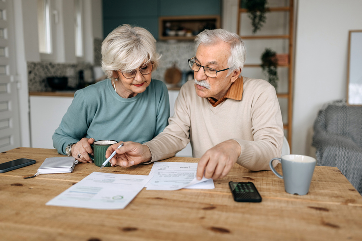 A senior couple calculating both median and average incomes.  