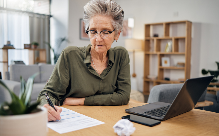 A senior woman reviewing a checklist for her estate plan.