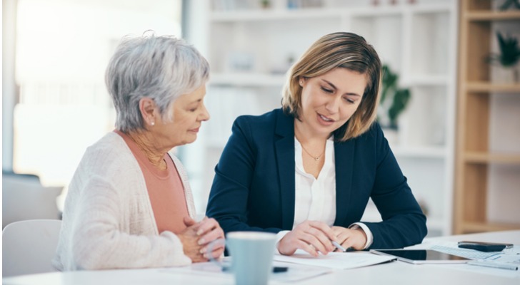 A woman goes over her retirement income plan with her financial advisor.