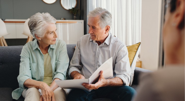 A retired couple goes over their will with their estate planning attorney.