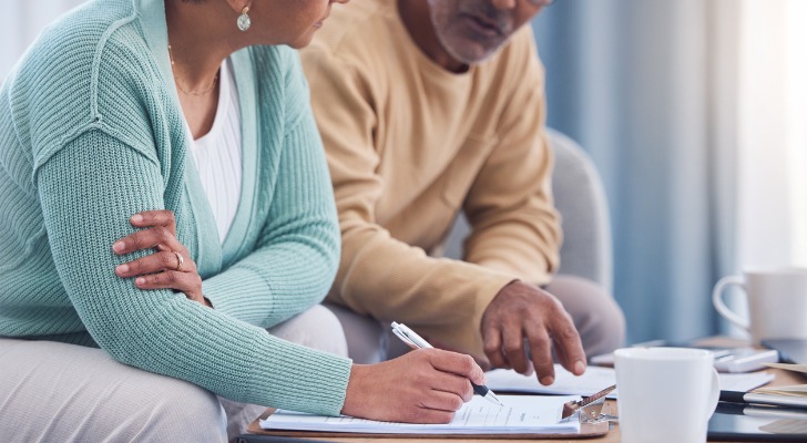 A senior couple reviews their wills as part of an estate plan in New York.