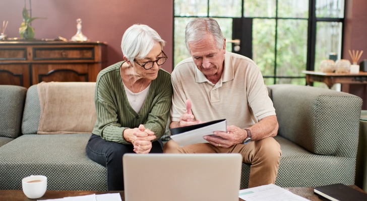 A senior couple reviewing the requirements for different tax breaks. 