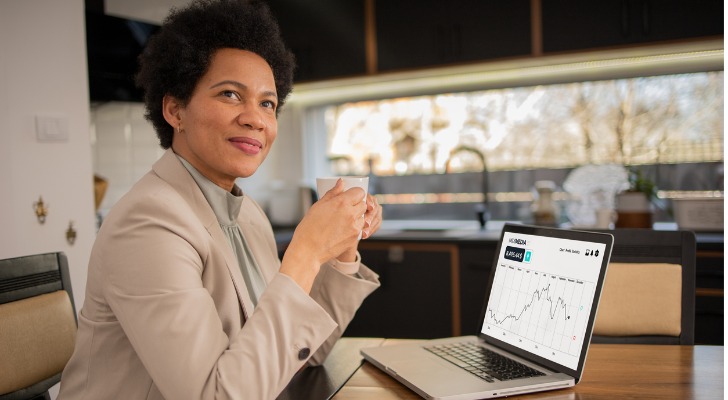 An woman evaluates a potential investment and considers trading options online.