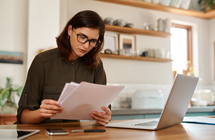 A tax filer reading a correction letter from the IRS.
