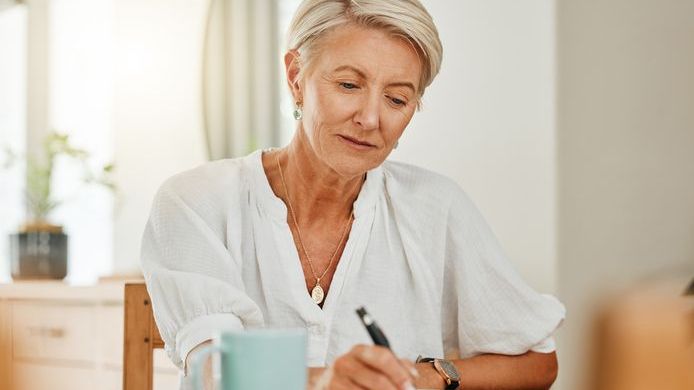 A woman looks over her finances and calculates how much of your Social Security benefits are taxable.