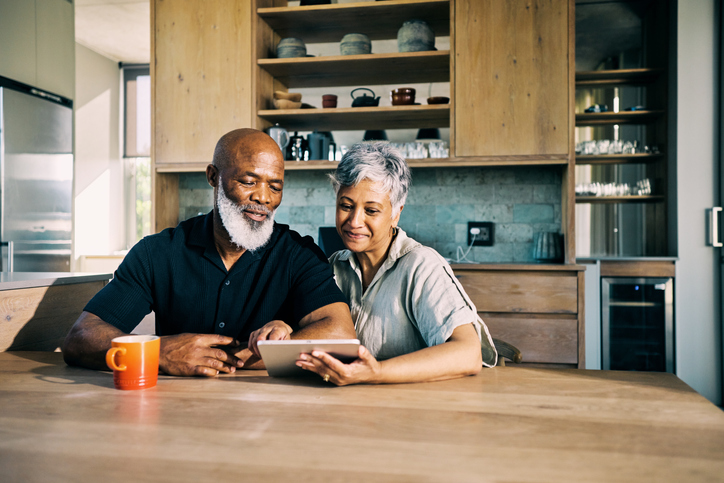 A senior couple researching for additional ways to plan their retirement. 