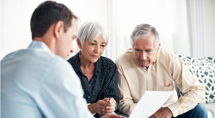 A couple in their 70s meets with a financial advisor to discuss their savings rate and financial plan.